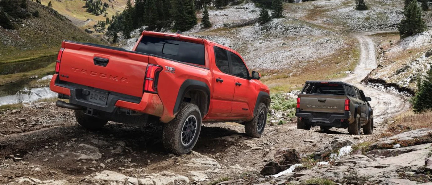 A shot of off-roading in an orange 2024 Toyota Tacoma